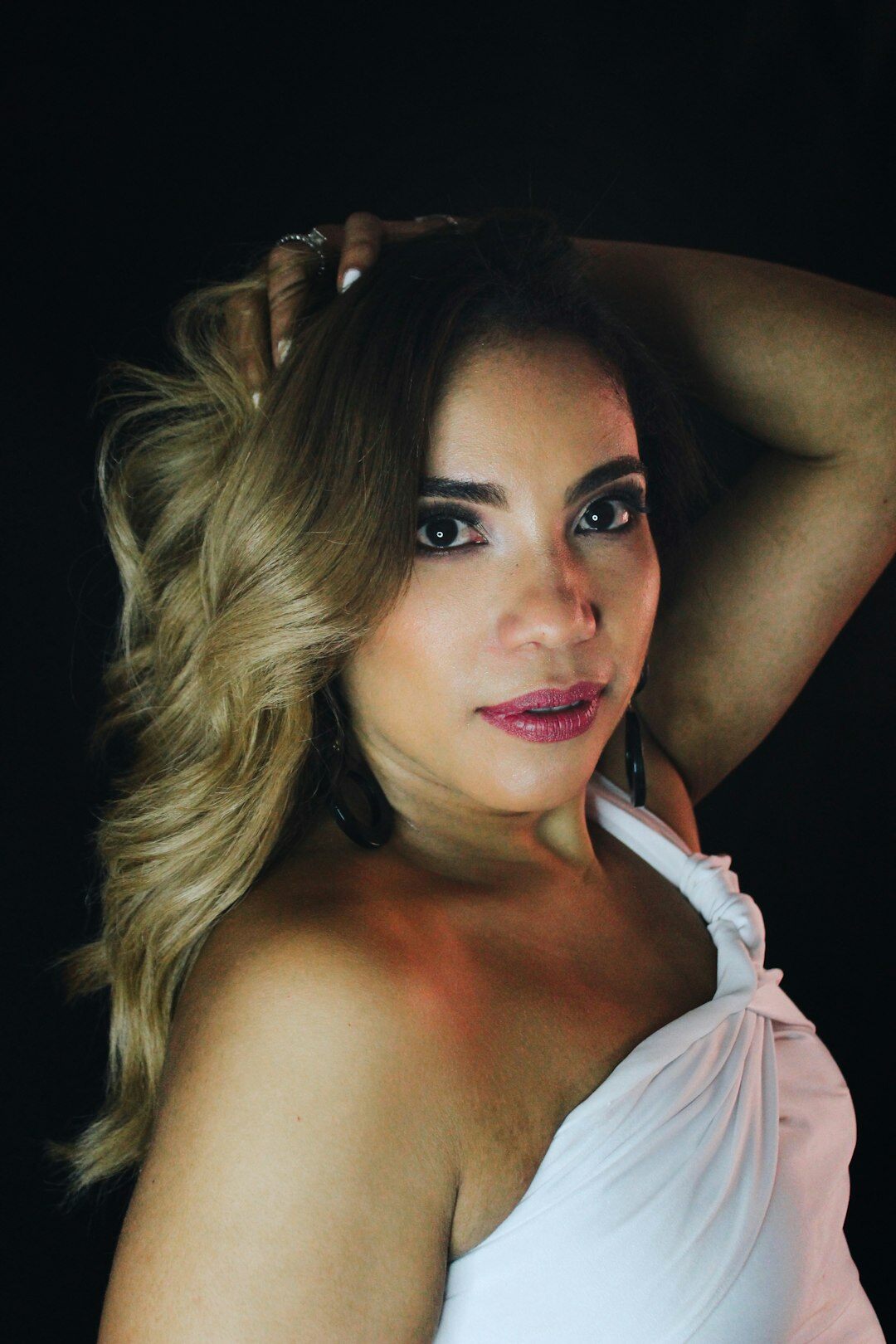Studio portrait of a Brazilian woman in her early thirties, client experience director